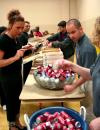 Mark Mogle helps serve pizza with his fellow SIFE members.  SIFE directed games, projects, and lunch for kids and teachers in the local area.   - Photo by Kristi McMurry
