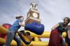 Kinsey Bolinger and Emily Watlington enjoy May Day by boxing in the inflatable ring set up for students on the great lawn by Miller Tower. - Photo by Kyle Kurlick