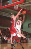 03/6/03 - Senior Derrick Underwood gets a burst of energy as he shoots for two over an opposing Lyon.