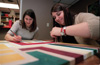 Assignment: Trading Spaces - In addition to painting the kitchen cabinets, senior Sarah Belcher, digital media studies major, and junior Jennifer Allen, art major, painted a canvas to hang in the kitchen. - Photo by Kristen Hiller