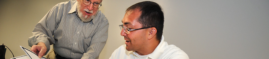 Dr. Ralph Leverett helps a student in class.