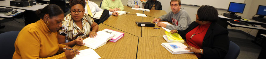 Education students take notes and listen in class.