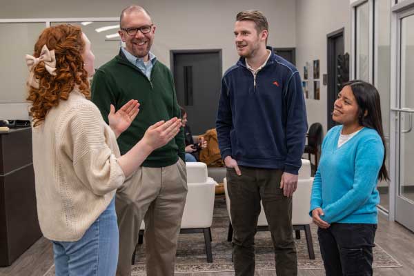 Students chatting with professor