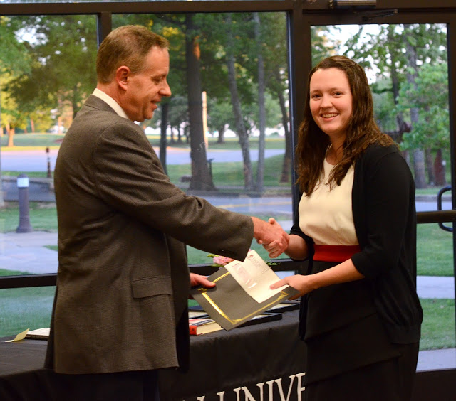 Dr. Henry Allen congratulates Lauren Geary at the department awards banquet on May 5, 2016, as he gives her the second place award in the Dr. James Alex Baggett History Research Paper Competition. Photo by MiKalla Cotton