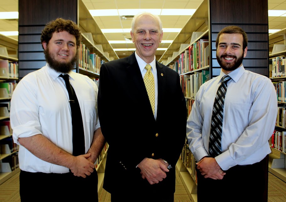 Phi Alpha Theta chapter leaders pause for a photo following a Best Chapter Award check presentation at the Union University library. They are (left to right) Nicholas Hancock, Dr. Stephen Carls, and Allen Bradley.