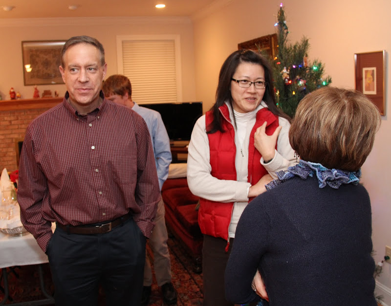 Dr. Henry Allen and his wife Haelim talk to Becky Lindley (back to camera) at the beginning of the Franco-American dinner at the Carls's home on December 5, 2015.
