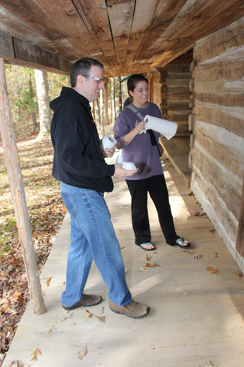 Dr. Keith Bates and Emily Littleton inspect their cabin window-cleaning work as participants in a Phi Alpha Theta-sponsored community service project at Britton Lane Battlefield on November 3, 2015.