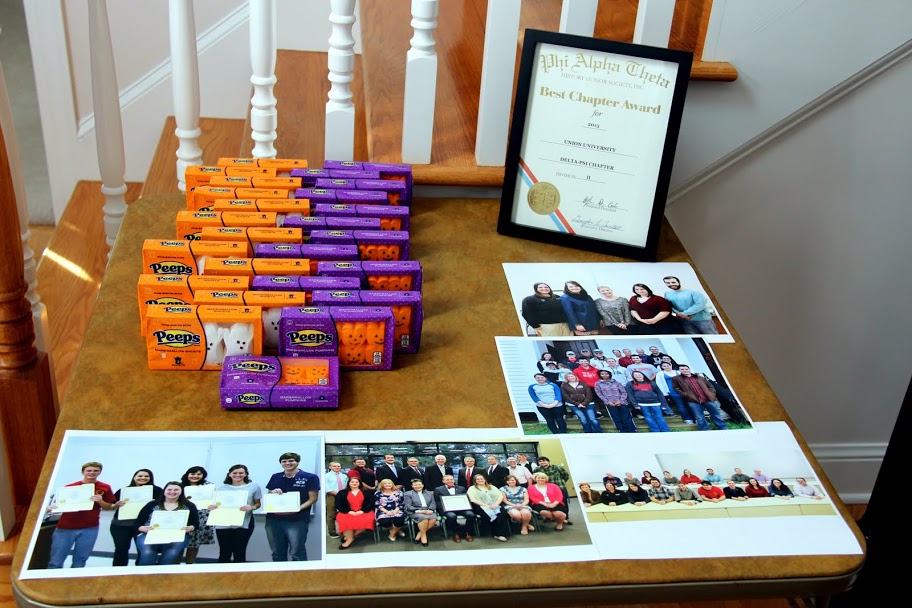A Phi Alpha Theta display table stands in the entryway of Dr. Stephen Carls's home for the Best Chapter Award pizza party on October 16, 2015