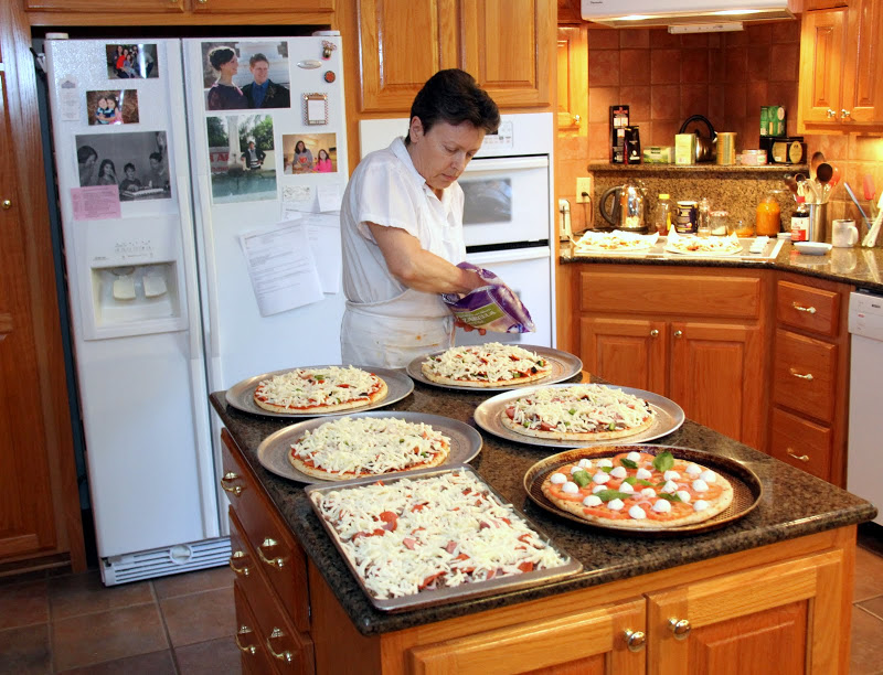 Hostess Dr. Alice-Catherine Carls prepares pizzas prior to the Phi Alpha Theta Best Chapter Award pizza party on October 16, 2015.