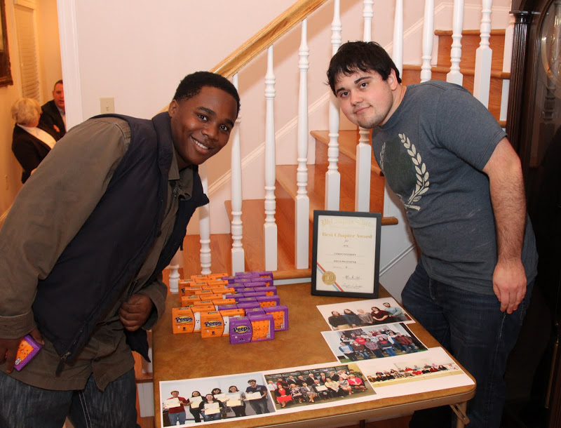 Trae Hall (left) and Ashton Hostetler stand by the Phi Alpha Theta Best Chapter Award display table at the Delta-Psi chapter's pizza party on October 16, 2015.