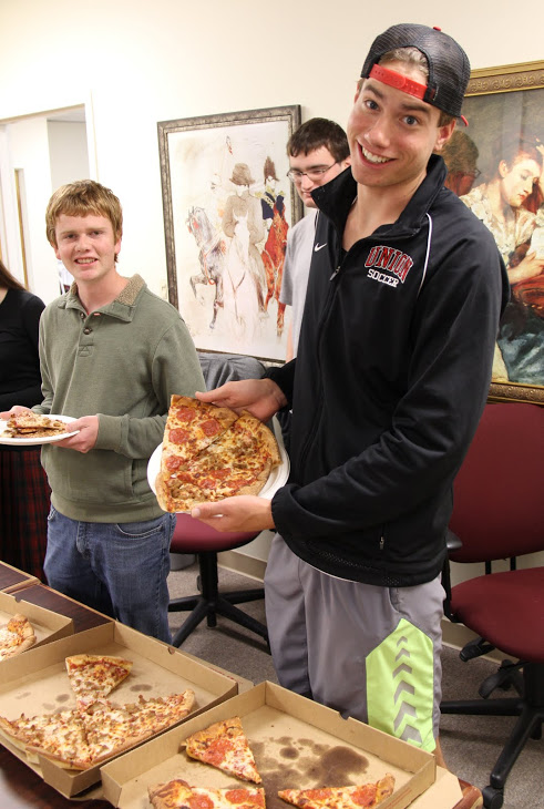 Stephen Lewoczko (right) shows off his selection of pizza slices at the Rutledge Honorary History Club's movie night on December 2, 2016. Next to him with a plate of pizza is history major Gideon Ragland.