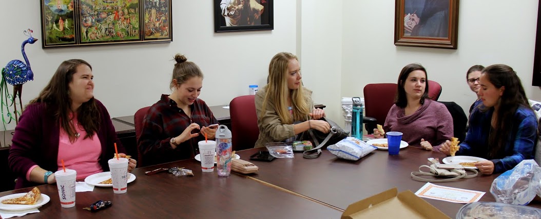 Attendees at the history club's movie night enjoy food and fellowship together. They are (left to right) Jessica Barton, Madison Hutcherson, Ali Renckens, Lydia Black, Emily Summers (behind), and Joanna Butcher.