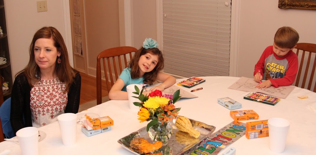 Lisa Bates (left) engages in conversation, while her daughter Rachel and son Colin demonstrate their artistic skills at the Phi Alpha Theta Best Chapter Award pizza party on October 21, 2016.