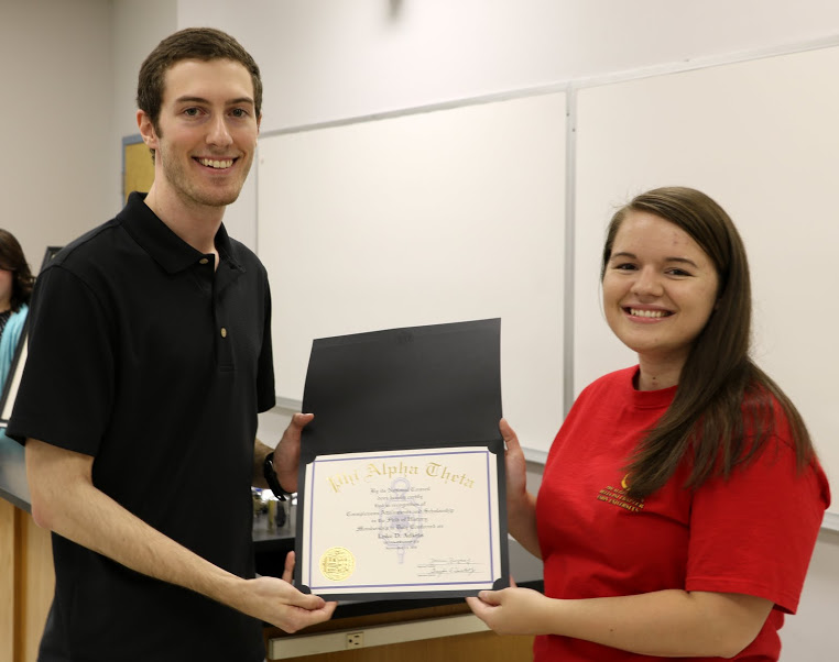 Delta-Psi President Jordan Sellers (right) presents Luke Adkins with his Phi Alpha Theta membership certificate at the chapter's fall plenary meeting on September 13, 2016. Photo by Elizabeth Wilson