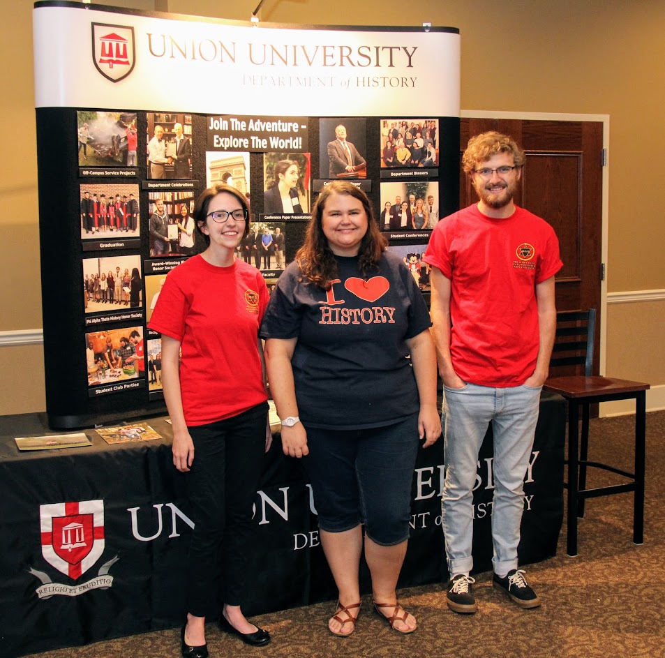 The history department's student representatives at the Campus Life Fair on August 19, 2018, pause for a photo. They are: (left to right) Lauren Butler, president of Union's Delta-Psi chapter of Phi Alpha Theta; Jessica Barton, president of the Rutledge Honorary History Club; and Luke Sower, vice president of the Delta-Psi chapter of Phi Alpha Theta.