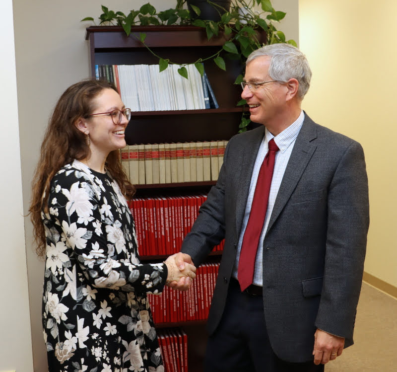 Dr. David Thomas, chair of Katie Allison's honors thesis committee, congratulates her on her successful thesis defense on December 9, 2019.