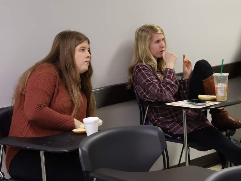 Hannah Ratliff (left) and Taylor Brown participate in the discussion over what movie to watch at the club's upcoming pizza party/movie night during the club's fall plenary meeting on November 11, 2019.