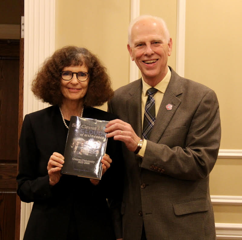 Dr. Stephen Carls presents a book on the history of Union University to Dr. Joan Waugh at a dinner in her honor on October 21, 2019.