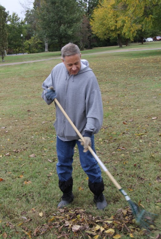 Dr. Henry Allen gathers up walnuts and leaves with his rake at Liberty Garden Park on the morning of October 29, 2019.