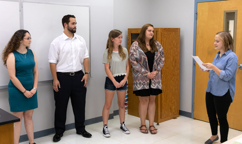 Phi Alpha Theta Vice President Megan Ledbetter (right) presides over the induction ceremony at the Delta-Psi chapter's fall plenary meeting on September 24, 2019. The initiates are (left to right) Johnna Wade, Nicholas Terra, Rebekah Lisle, and Sandra Allen. Photo by Joey Echeverria
