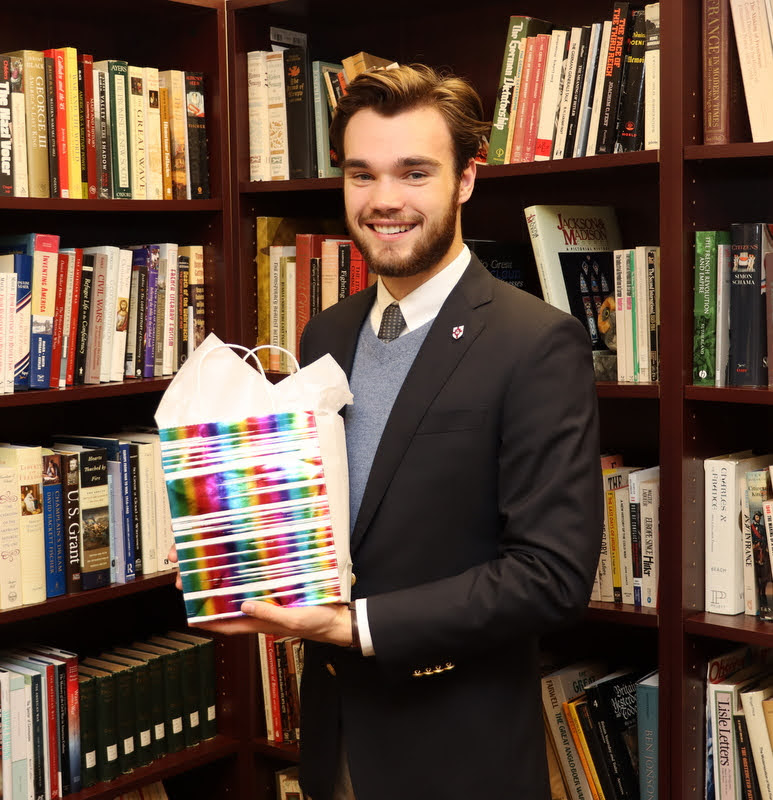 Graduating history major and Phi Alpha Theta member Jack Waters accepts his history department awards packet on December 8, 2021.