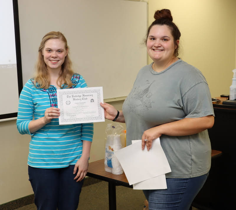 Anna Guelcher (left) accepts her Rutledge Honorary History Club certificate of membership from President Sandra Allen on October 7, 2021.