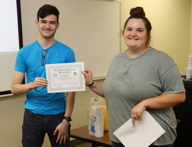 Seth Blair accepts his Rutledge Honorary History Club membership from President Sandra Allen at the club's plenary meeting on October 7, 2021.