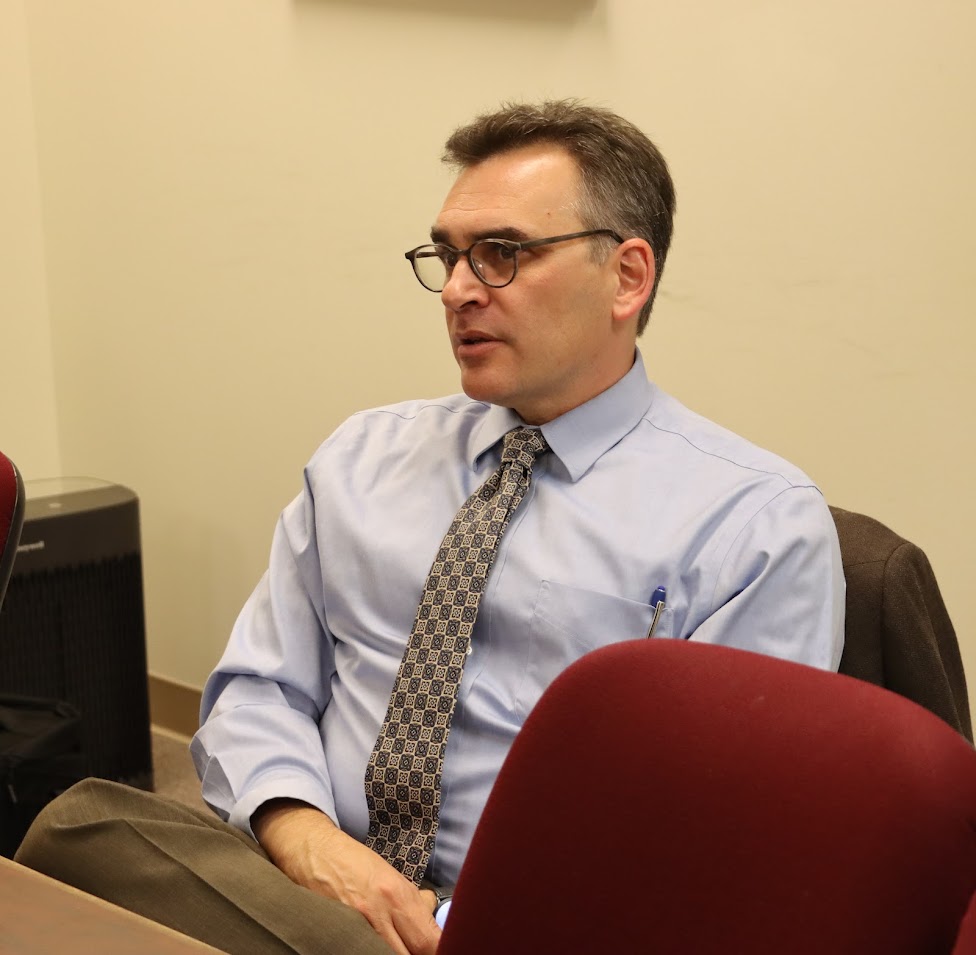 Dr. Michael Neiberg talks with history department faculty members during an afternoon coffee time on October 24, 2022.