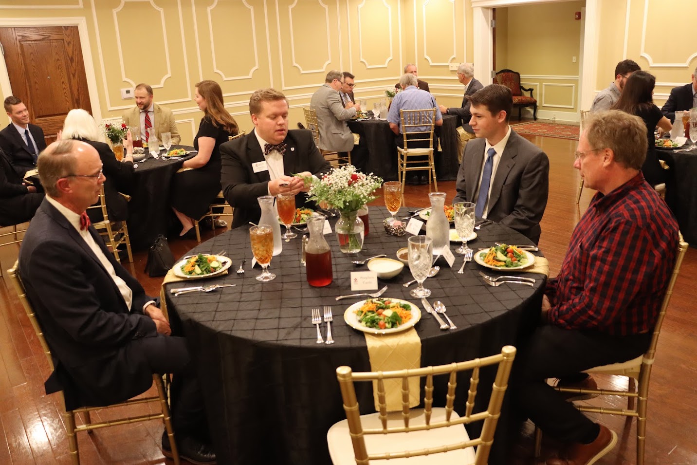 Attendees at a dinner in honor of Dr. Michael Neiberg enjoy good food and conversation on October 24, 2022. Seated at the table directly in front of the camera are (left to right) Robert Briley, Colby Benefield, Noah Kea, and Shane Lynch.
