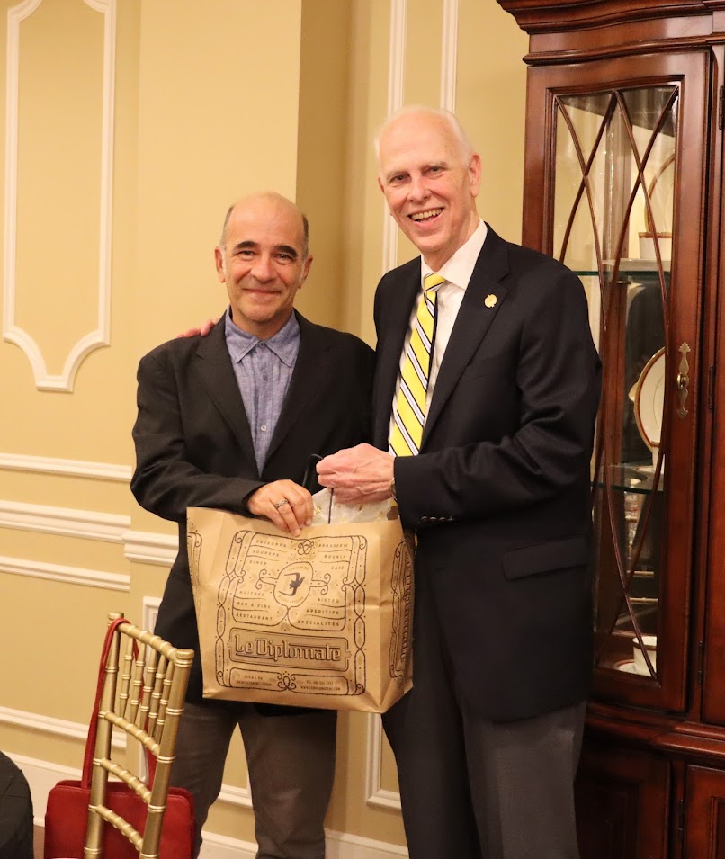 Dr. Michael LaRosa (left) of Rhodes College presents an appreciation gift to Dr. Stephen Carls at a dinner in honor of the Carls-Schwerdfeger Lectureship speaker, Dr. Michael Neiberg, on October 24, 2022.