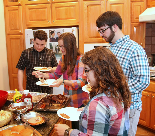 Guests go through the food  line at the Phi Alpha Theta cookout on May 8, 2015. They are (starting on the left, going clockwise) Nic Linn, Bree McCuin, Charles Snow, and Nicole Martin.