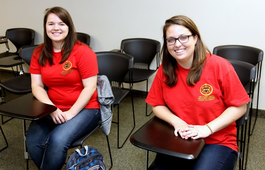 Phi Alpha Theta members Jordan Sellers (left) and Emily Littleton show off their Delta-Psi chapter T-shirts after a history class on April 11, 2016.