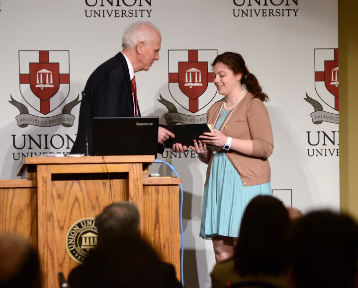 Dr. Stephen Carls presents the winning award in the graduate student history paper competition to Alexandria Poppendorf of Austin Peay State University at the Phi Alpha Theta regional conference luncheon on April 2, 2016. Photo by MiKalla Cotton
