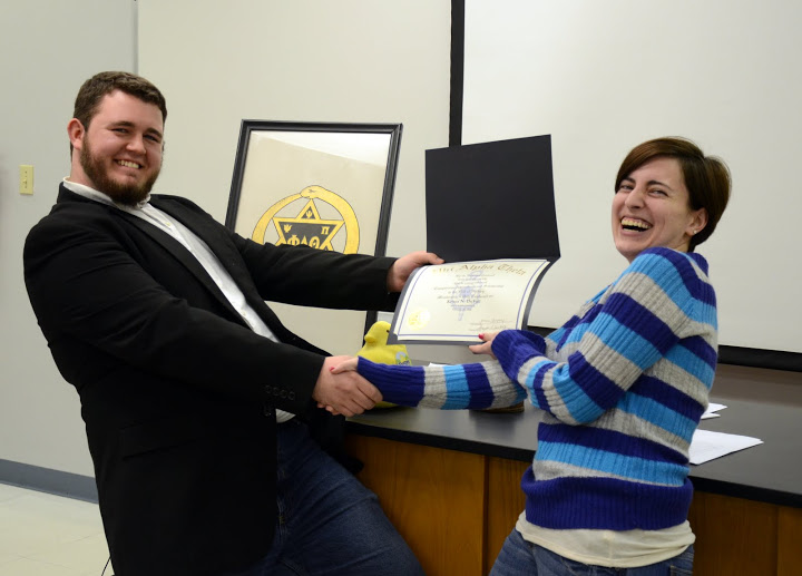 Delta-Psi President Nicholas Hancock and new Phi Alpha Theta member Kelsea DuVall have a fun moment together as he presents a certificate of membership to her at the society's plenary meeting on February 22, 2016. Photo by Elizabeth Wilson