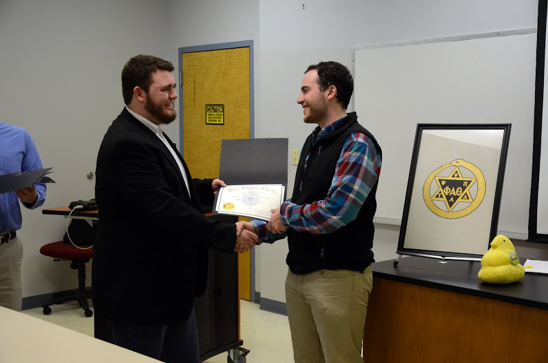 Phi Alpha Theta President Nicholas Hancock congratulates Jeremy Ebert on becoming a member of the society as he presents him with his membership certificate on February 22, 2016. Photo by Elizabeth Wilson