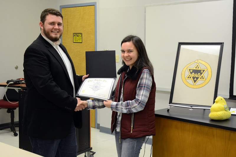 Phi Alpha Theta President Nicholas Hancock presents a certificate of membership to Alexandra Martin at the Delta-Psi chapter's plenary meeting on February 22, 2016. Photo by Elizabeth Wilson