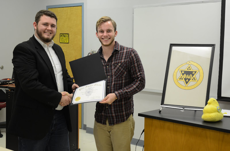 Seth Reid (right) receives his Phi Alpha Theta membership certificate from Delta-Psi President Nicholas Hancock at the chapter's plenary meeting on February 22, 2016. Photo by Elizabeth Wilson