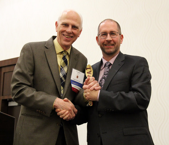 Drs. Stephen Carls and Jochen Burgtorf smile during the passing of the Phi Alpha Theta presidential spoon at the end of the Presidential Banquet on January 9, 2016.