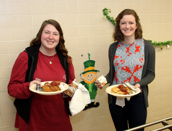 Delta-Psi chapter members Kathryn Mitchell (left) and Beth Adams get ready to go to a table at the Jackson Old Hickory Rotary Club Pancake Breakfast on March 12, 2016.