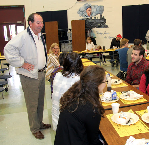 Jackson Old Hickory Rotary Club member Glen Vanderford (standing) talks with Union University students at the club's annual pancake breakfast on March 12, 2016.