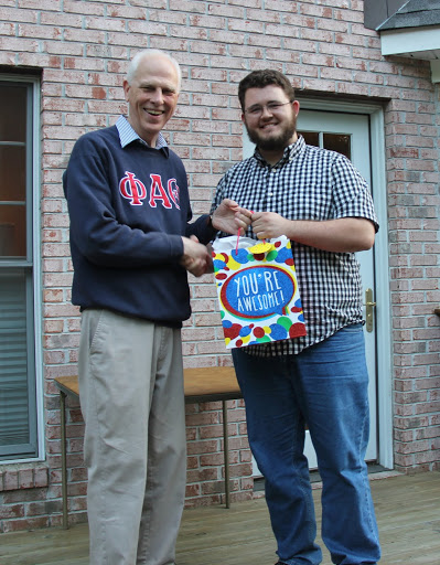 Nicholas Hancock (right) receives a graduation bag from Dr. Stephen Carls at the Phi Alpha Theta/History Department cookout on May 13, 2016.