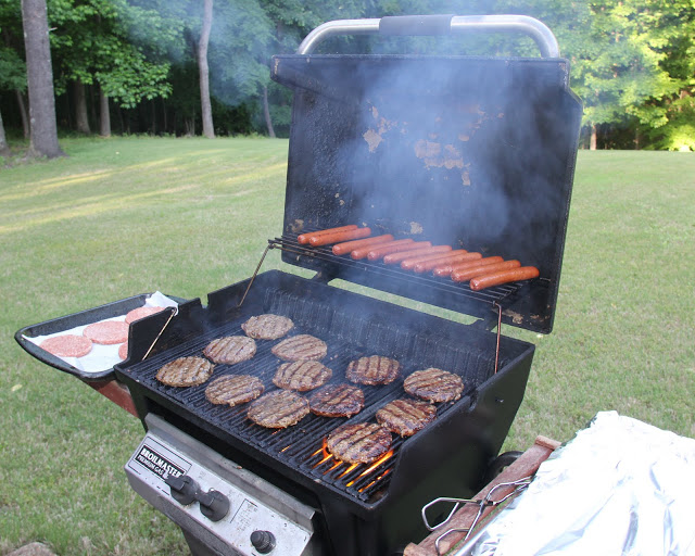 Hamburgers and hot dogs are readied on the grill at the annual Phi Alpha Theta cookout at Dr. Stephen Carls's home on May 13, 2016.