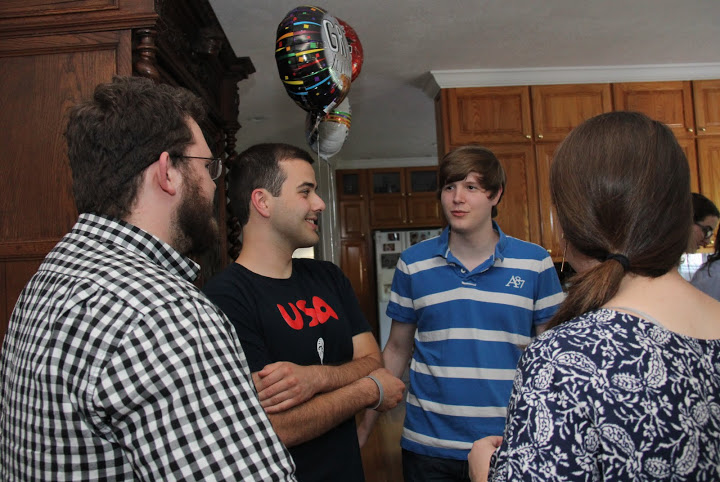 Attendees engage in conversation at the 24th Annual Phi Alpha Theta/History Department Cookout on May 13, 2016. They are (left to right) Nicholas Hancock, Allen Bradley, Thomas Gray, and Emily Littleton (back to camera).