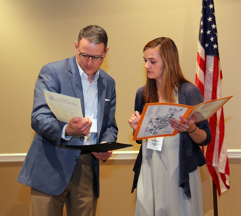 Georgia Brown explains to Dr. Keith Bates how to obtain a book from Phi Alpha Theta national headquarters as part of the second place award that Emily Littleton won in the American history paper competition at the Phi Alpha Theta regional conference at UT Martin on April 1, 2017.