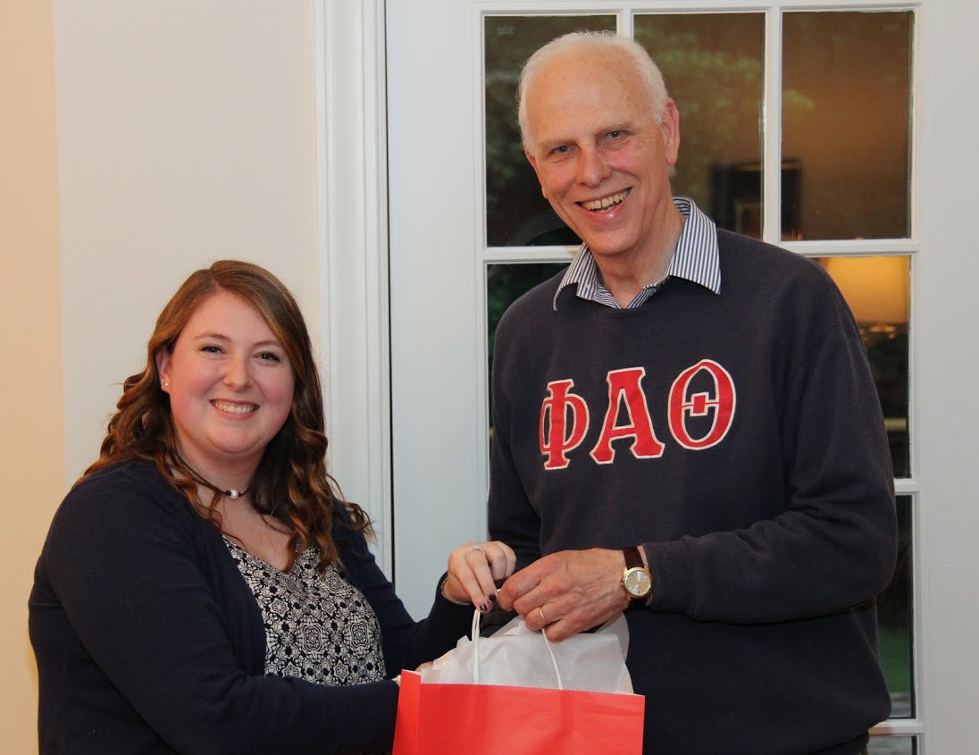 Kathryn Mitchell accepts a graduation award bag from Dr. Stephen Carls at the Phi Alpha Theta cookout on May 12, 2017, in recognition of her completion of a bachelor of science program at Union University.