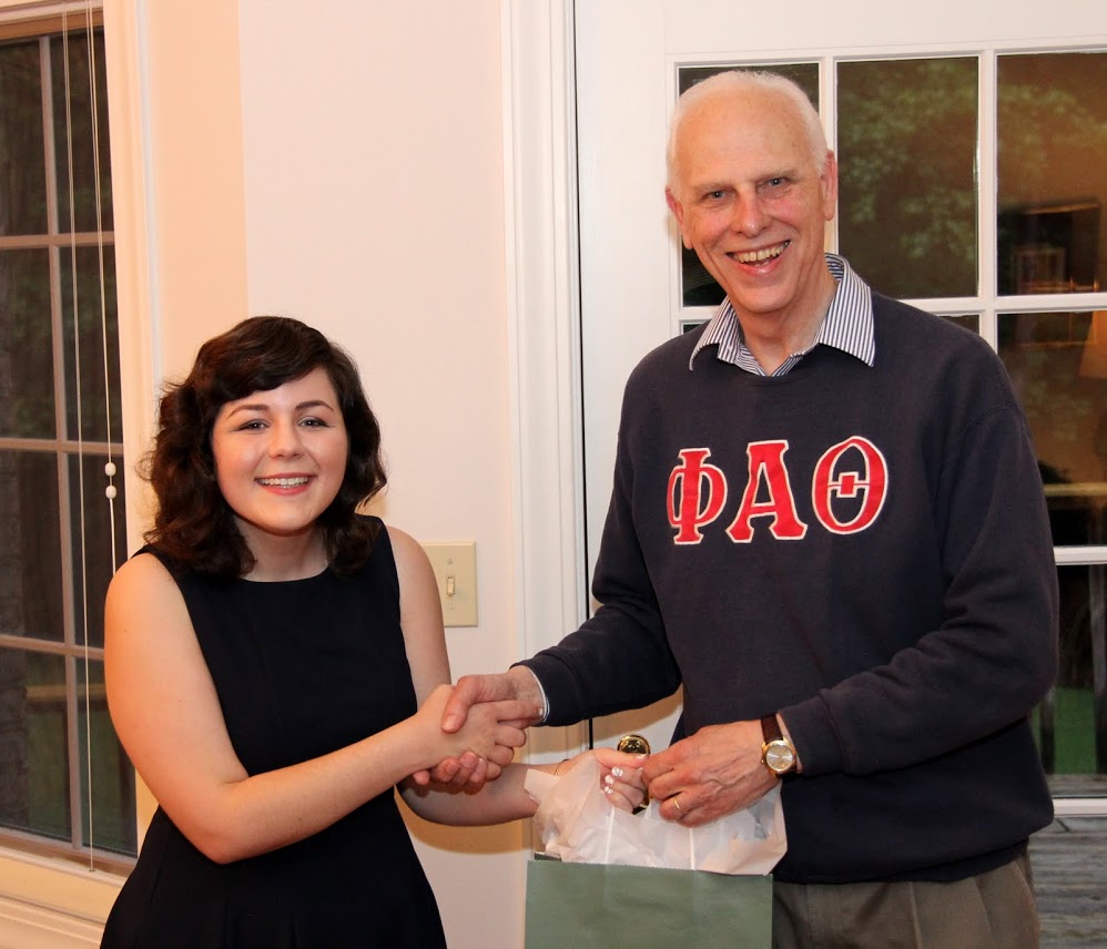 Graduating Phi Alpha Theta member Priscilla Porter accepts congratulations and an gift award bag from Dr. Stephen Carls at the history department cookout on May 12, 2017.