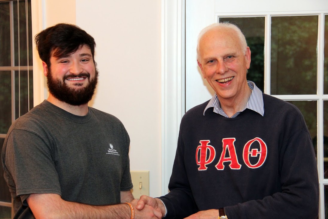 Luke Parrett (left) accepts congratulations from Dr. Stephen Carls at the history department cookout on May 12, 2017, for his completion of a bachelor of science program at Union University.