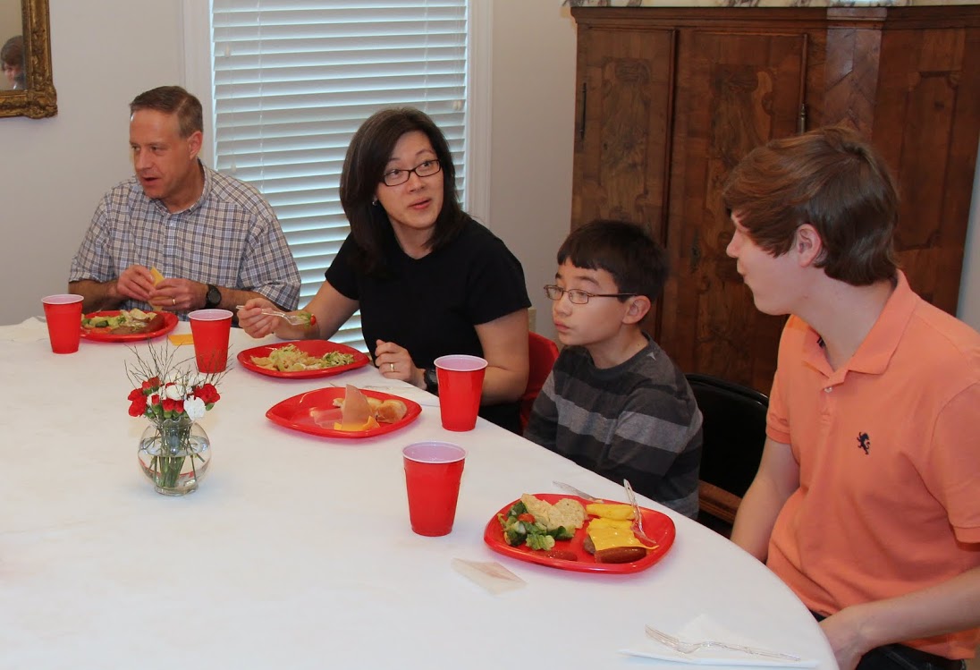 Attendees at the Phi Alpha Theta cookout on May 12, 2017, engage in table conversations during the meal. They are (left to right) Dr. Henry Allen, Haelim Allen, Matthew Allen, and Thomas Gray.