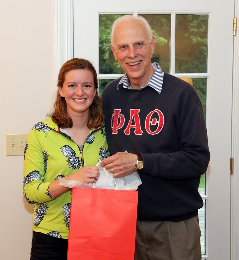 Beth Adams accepts a graduation gift award bag from Dr. Stephen Carls at the Phi Alpha Theta cookout on May 12, 2017.
