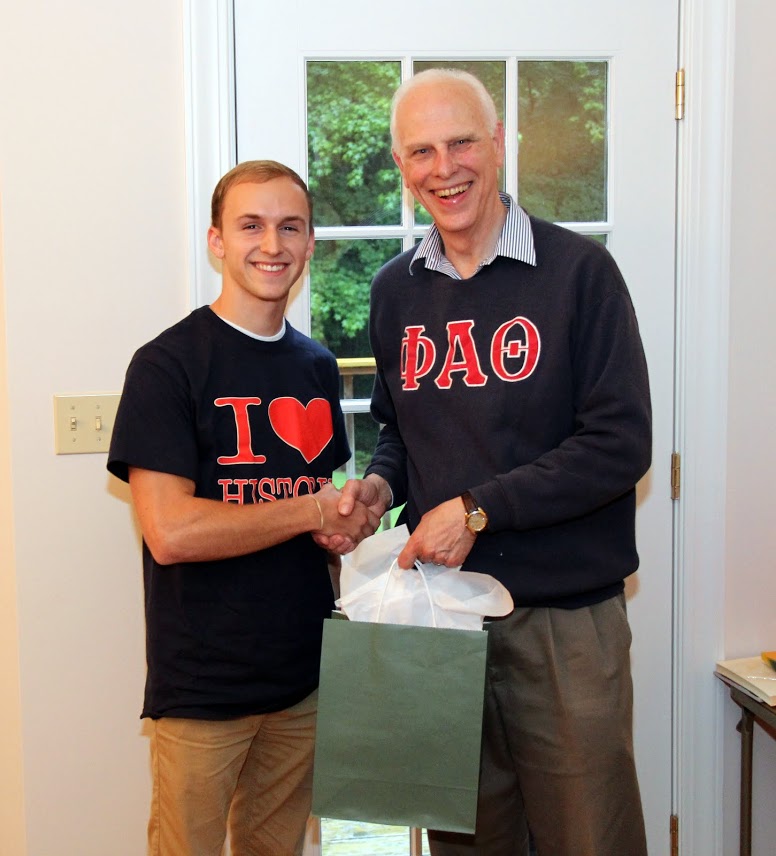 Devin Dean (left) accepts congratulations from Dr. Stephen Carls at the history department cookout on May 12, 2017, for his completion of a bachelor of science program at Union University.
